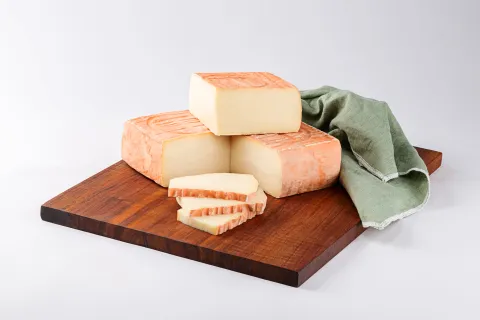 Forme e fette di Taleggio su un tagliere