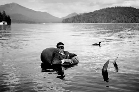 Fotografia Jake in inner tube with duck di Rodney Smith